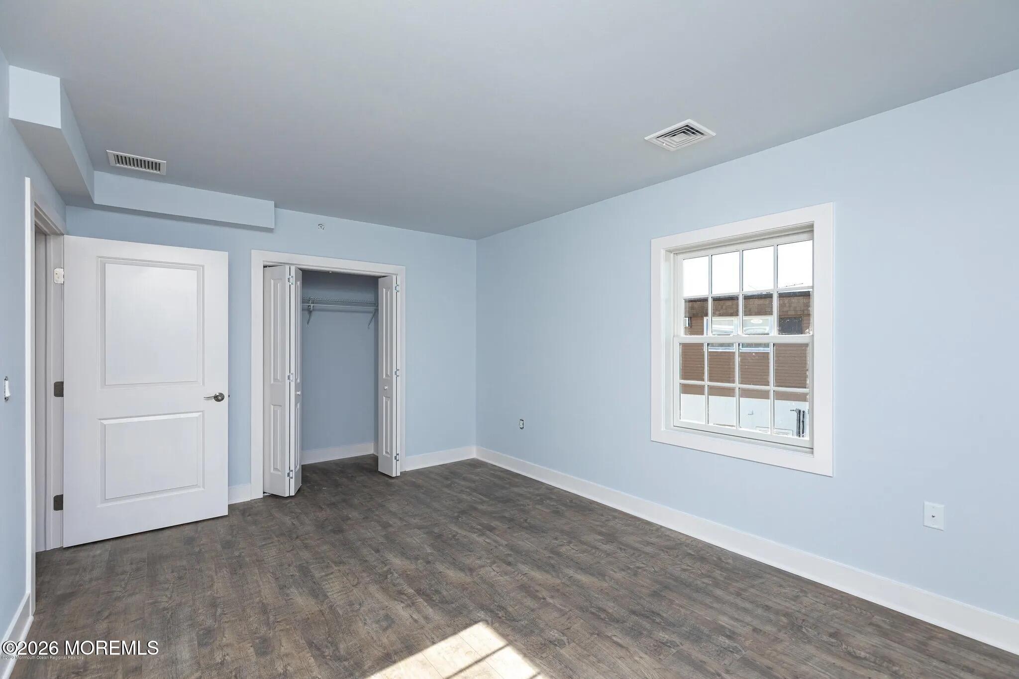 1009 Arnold Avenue, Unit 2A Point Pleasant, NJ 08742 - Photo 6 of 13 a view of an empty room with a window