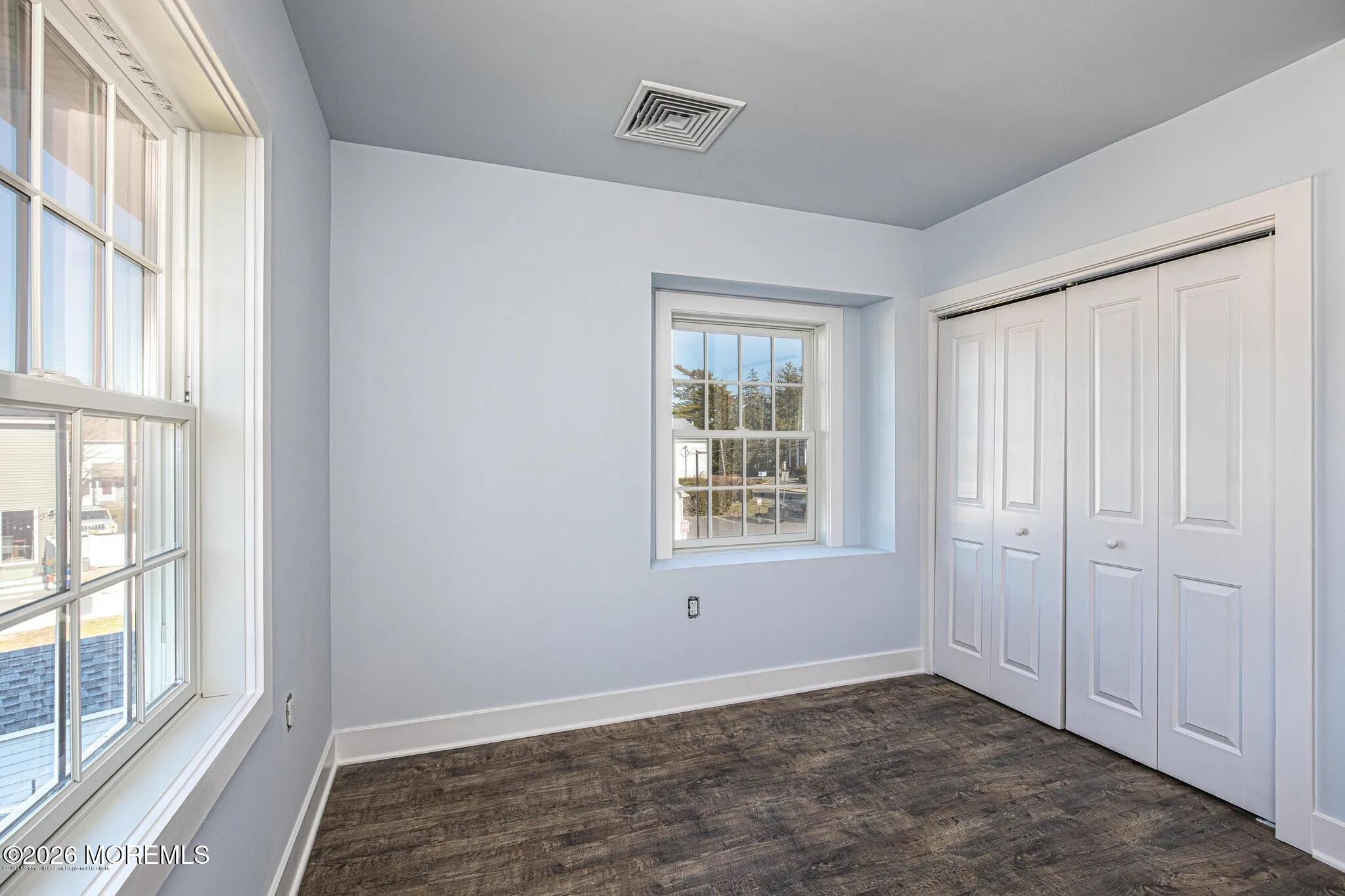 1009 Arnold Avenue, Unit 2A Point Pleasant, NJ 08742 - Photo 8 of 13 an empty room with windows