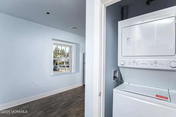a view of a hallway with washer and dryer