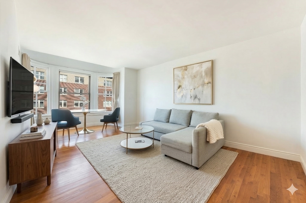 4 Charlesgate East, Unit 703 Boston, MA 02215 - Photo 2 of 15 a living room with furniture a flat screen tv and a window