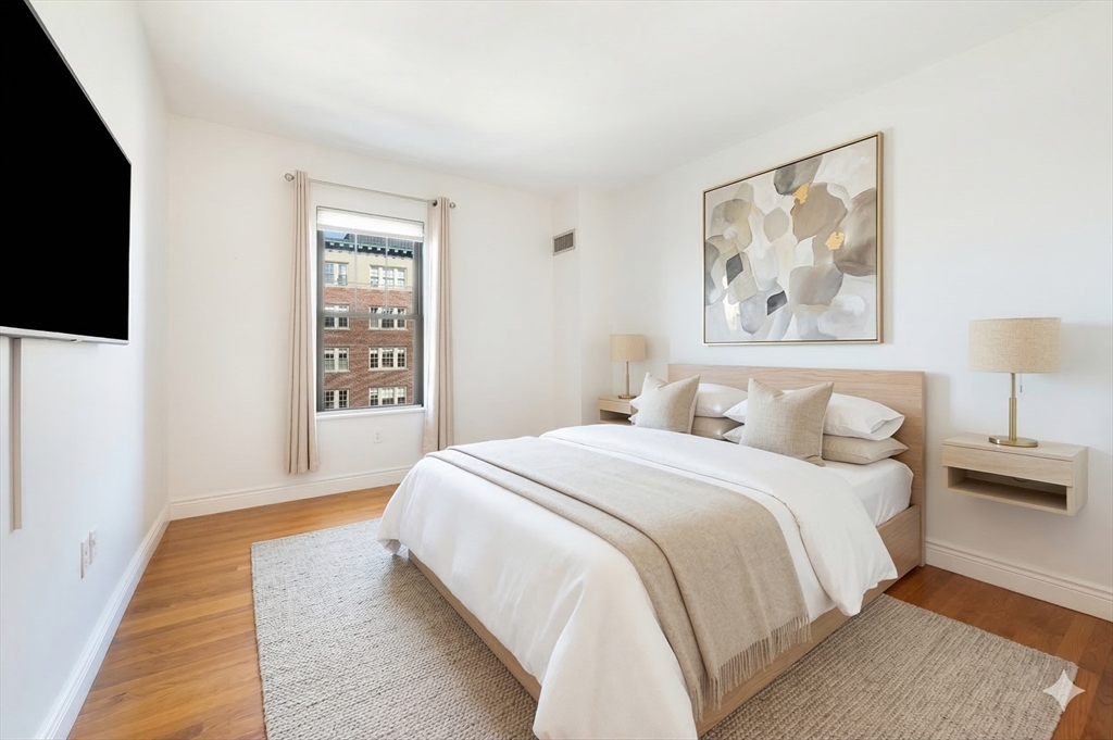 4 Charlesgate East, Unit 703 Boston, MA 02215 - Photo 7 of 15 a spacious bedroom with a bed and a flat screen tv