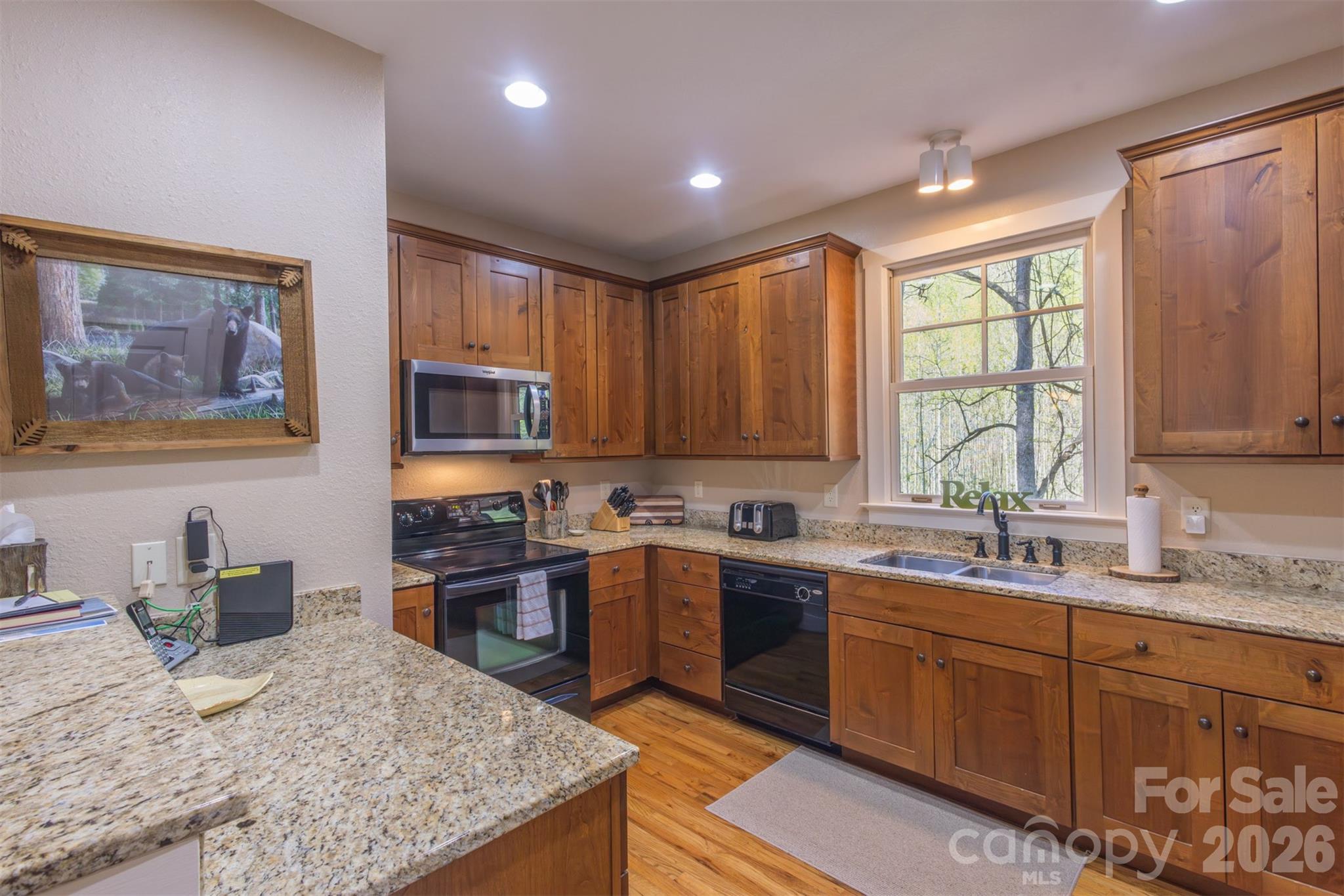 82 Mdw Rdg Court Tuckasegee, NC 28783 - Photo 11 of 39 a kitchen with stainless steel appliances granite countertop sink stove refrigerator and cabinets