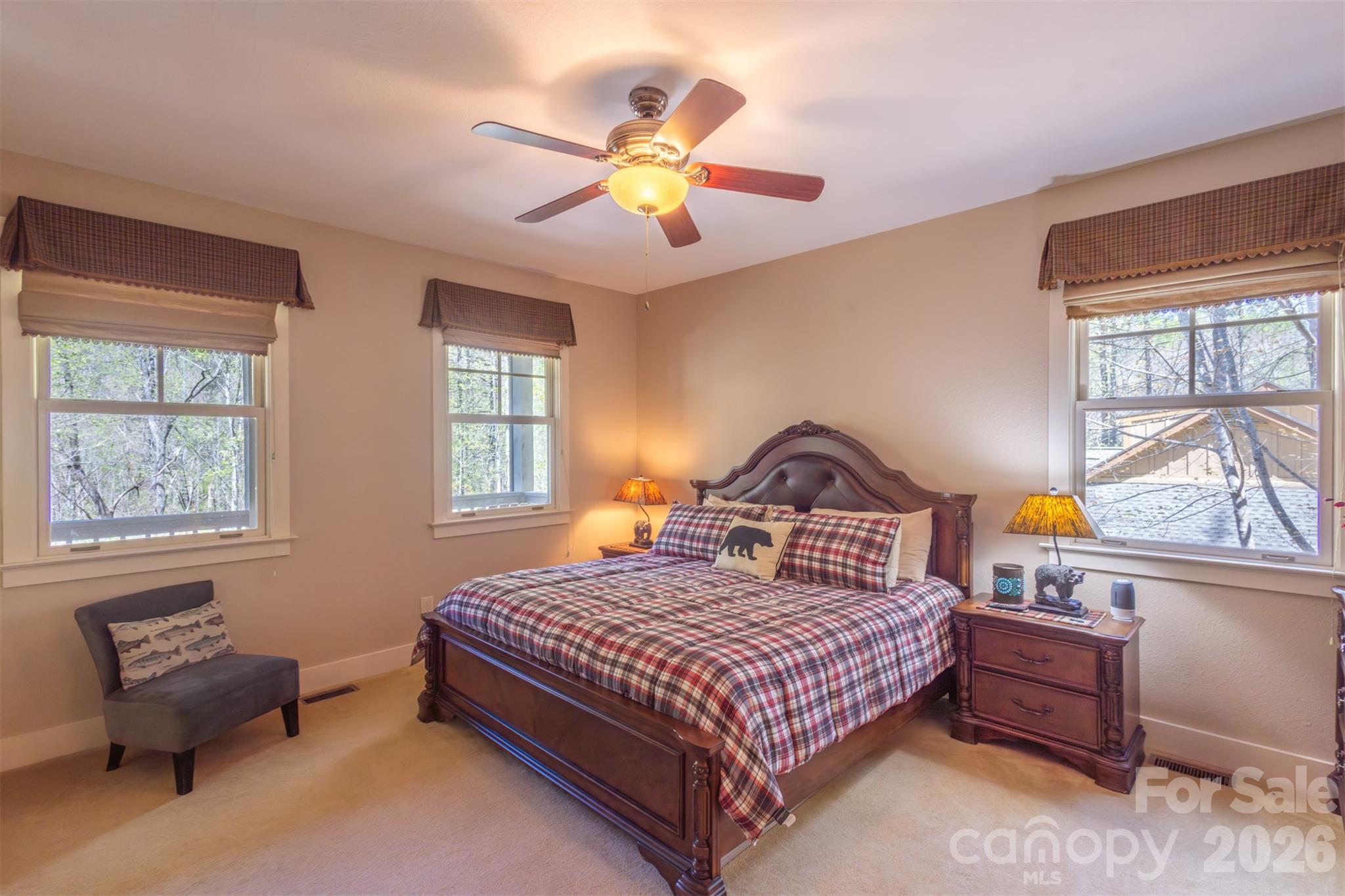 82 Mdw Rdg Court Tuckasegee, NC 28783 - Photo 16 of 39 a bedroom with a bed and a chandelier