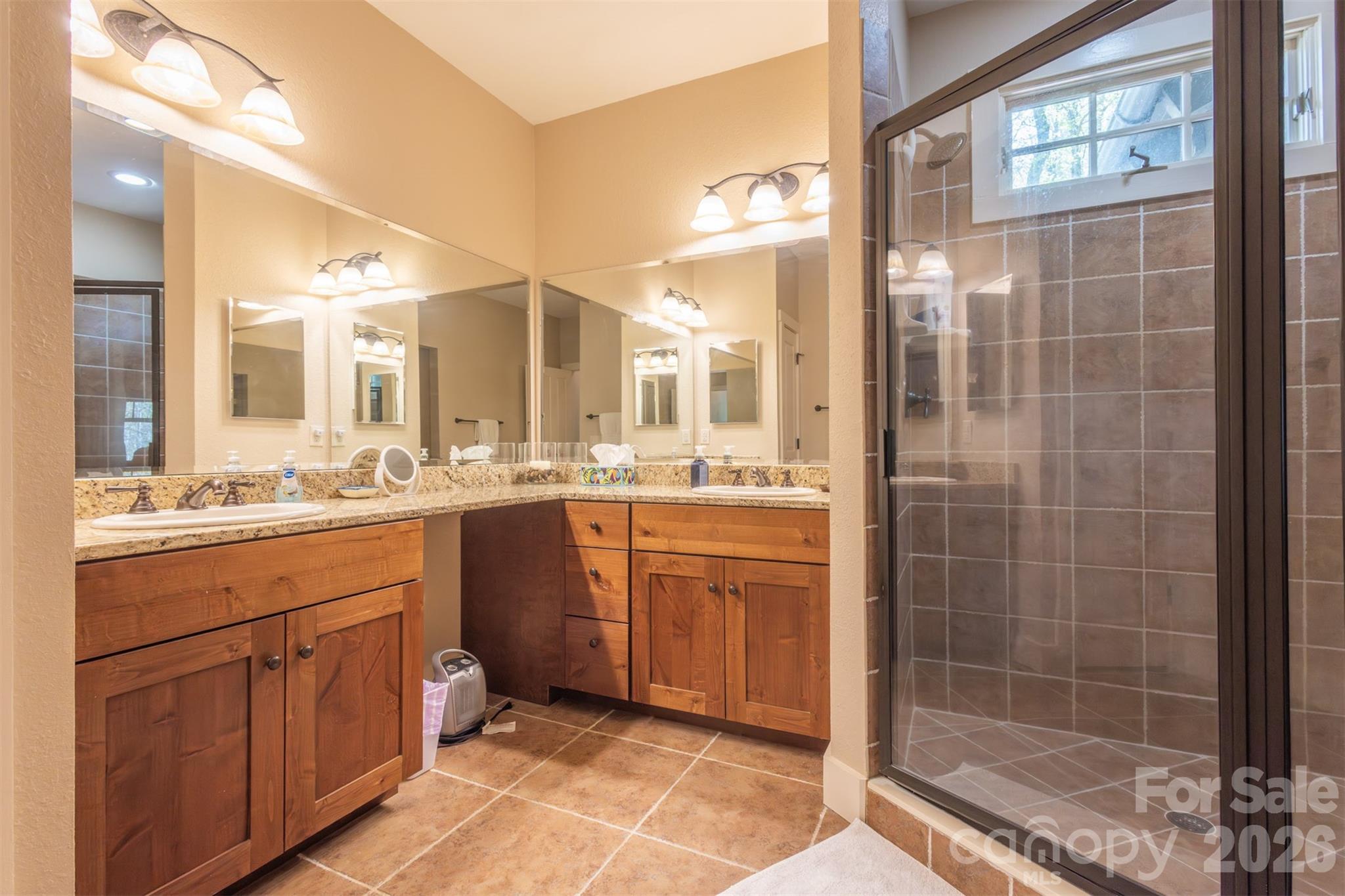 82 Mdw Rdg Court Tuckasegee, NC 28783 - Photo 18 of 39 a bathroom with a shower a sink and mirror