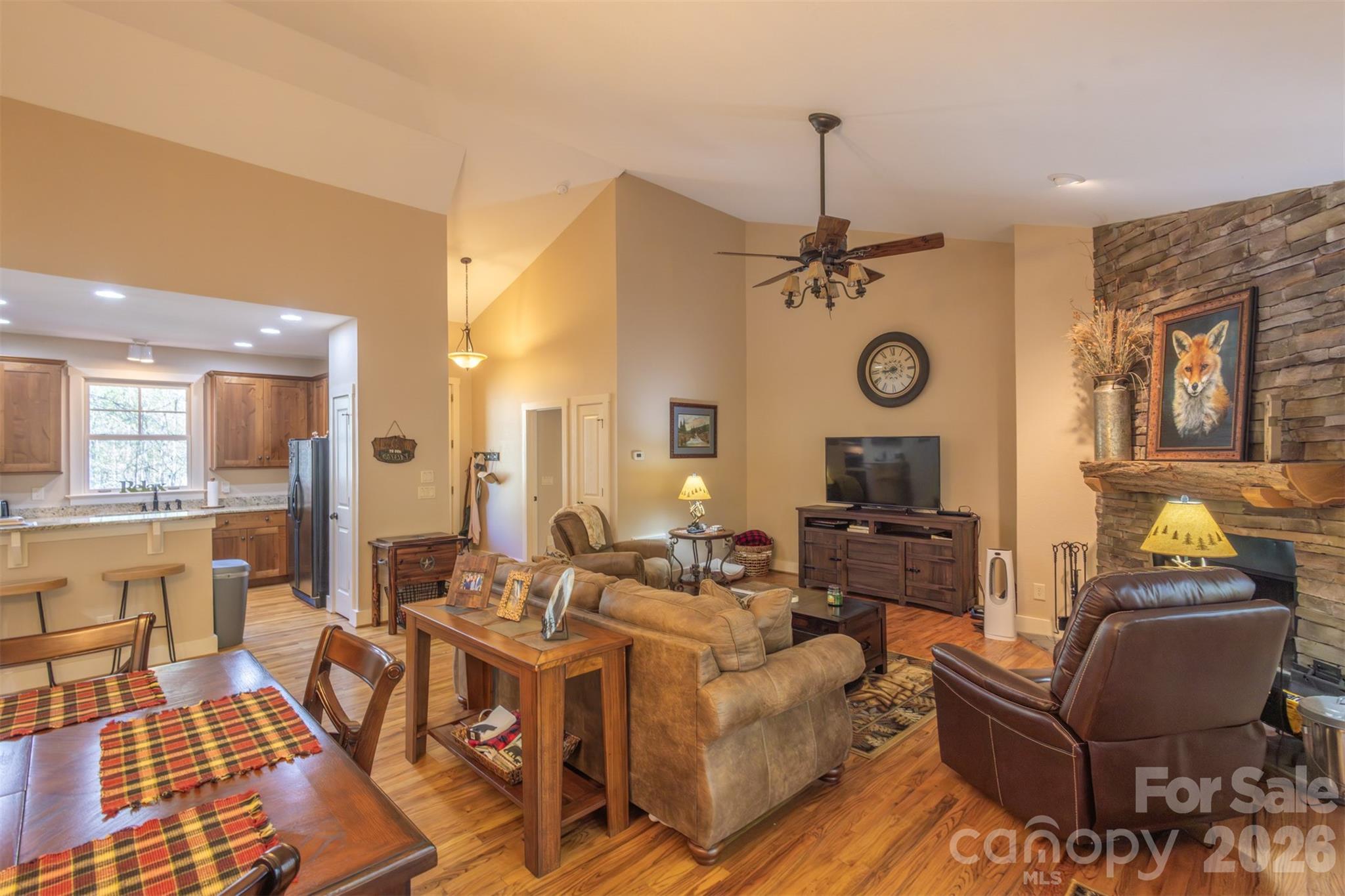 82 Mdw Rdg Court Tuckasegee, NC 28783 - Photo 8 of 39 a living room with couches a dining table and chairs with a bookshelf