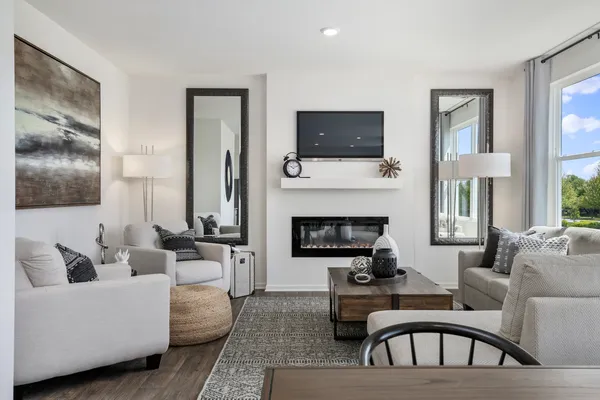 a living room with furniture a flat screen tv and a fireplace