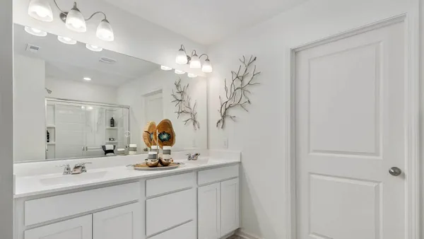a bathroom with a double vanity sink and a mirror