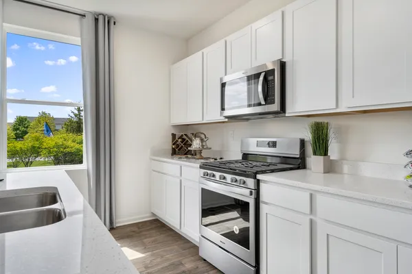 a kitchen with stainless steel appliances granite countertop a stove and a sink