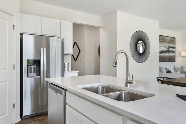 a kitchen with a refrigerator and a sink