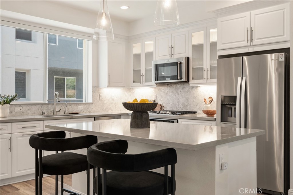 161 Steely Irvine, CA 92614 - Photo 2 of 35 a kitchen with stainless steel appliances granite countertop a sink refrigerator and cabinets