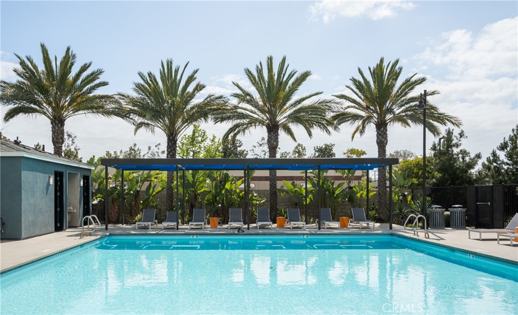 161 Steely Irvine, CA 92614 - Photo 32 of 35 a view of a swimming pool with a patio and a yard with palm trees