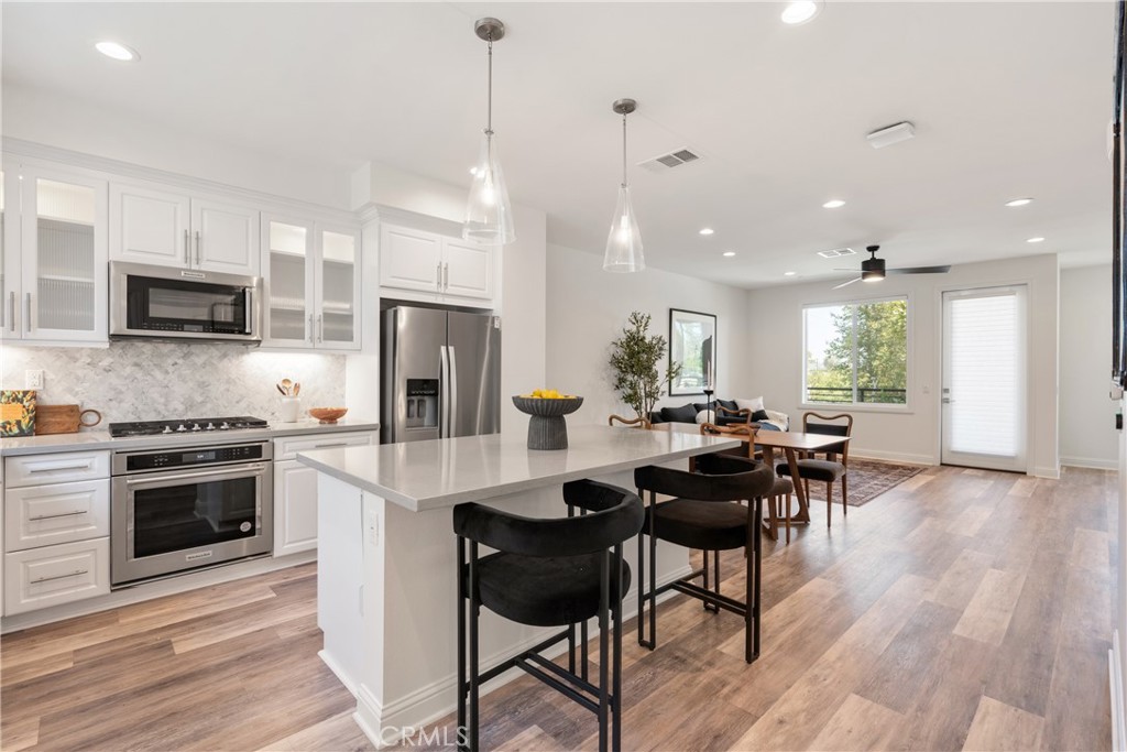 161 Steely Irvine, CA 92614 - Photo 6 of 35 a kitchen with a dining table chairs and refrigerator