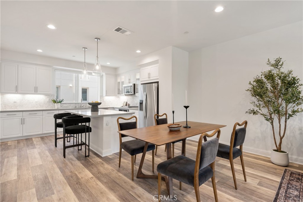 161 Steely Irvine, CA 92614 - Photo 10 of 35 a kitchen with refrigerator and chairs