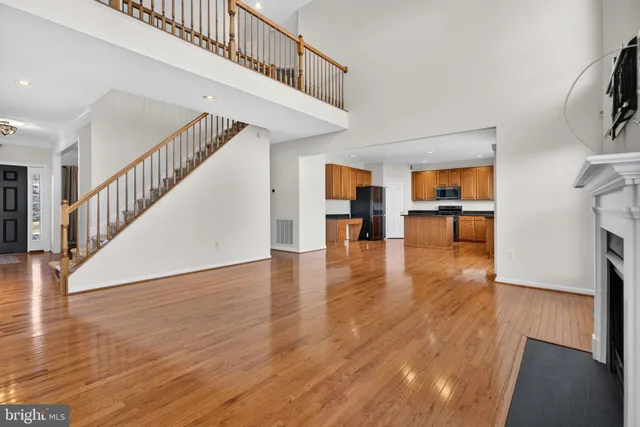 a view of a livingroom with wooden floor and a ceiling fan