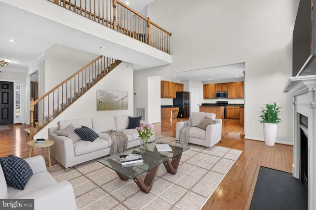 an empty room with windows and ceiling fan