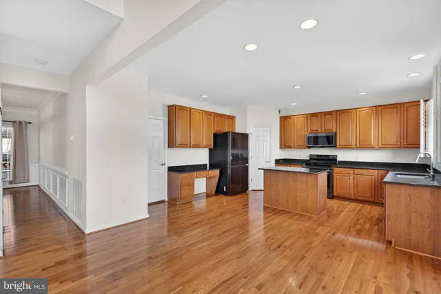 a view of an empty room and chandelier fan