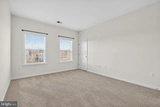 a bath tub sitting in a bathroom next to a window