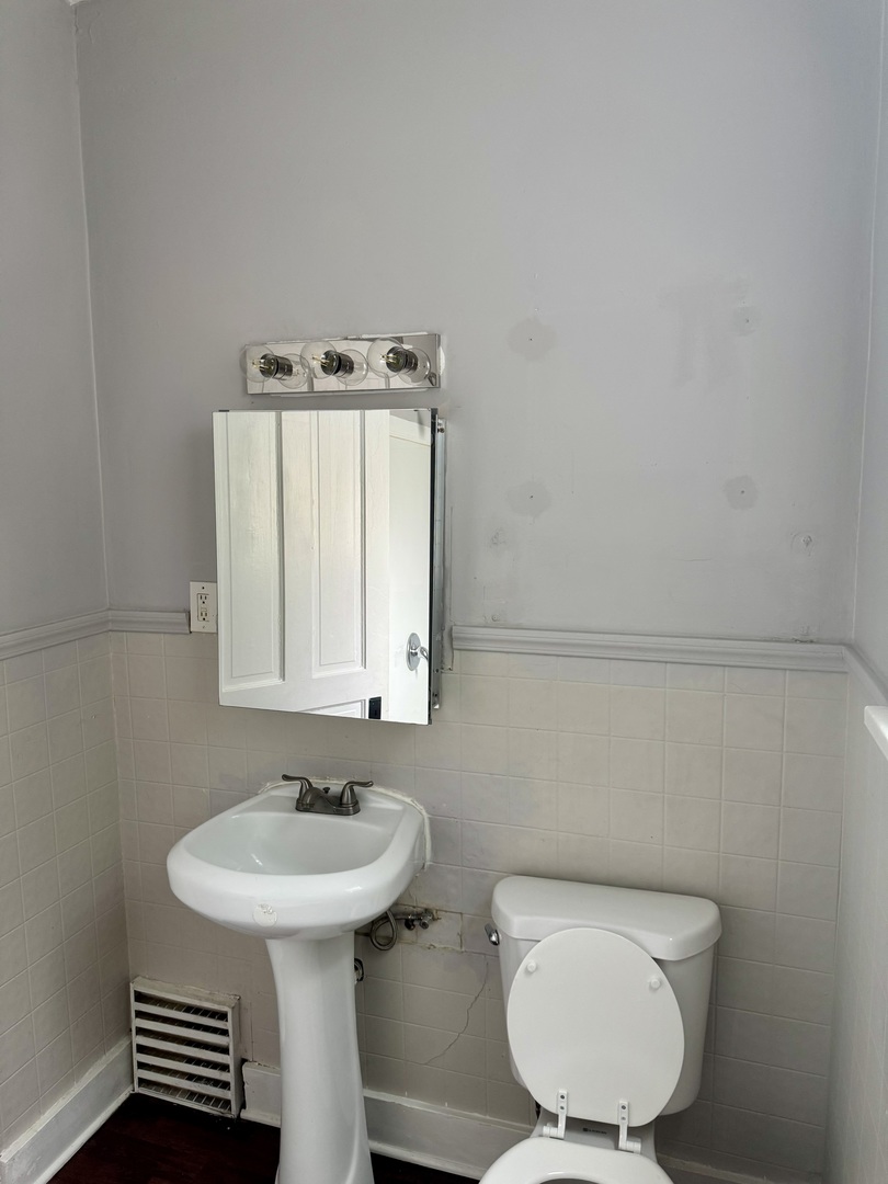 118 Wilcox Avenue Elgin, IL 60123 - Photo 18 of 29 a bathroom with a sink a toilet and mirror