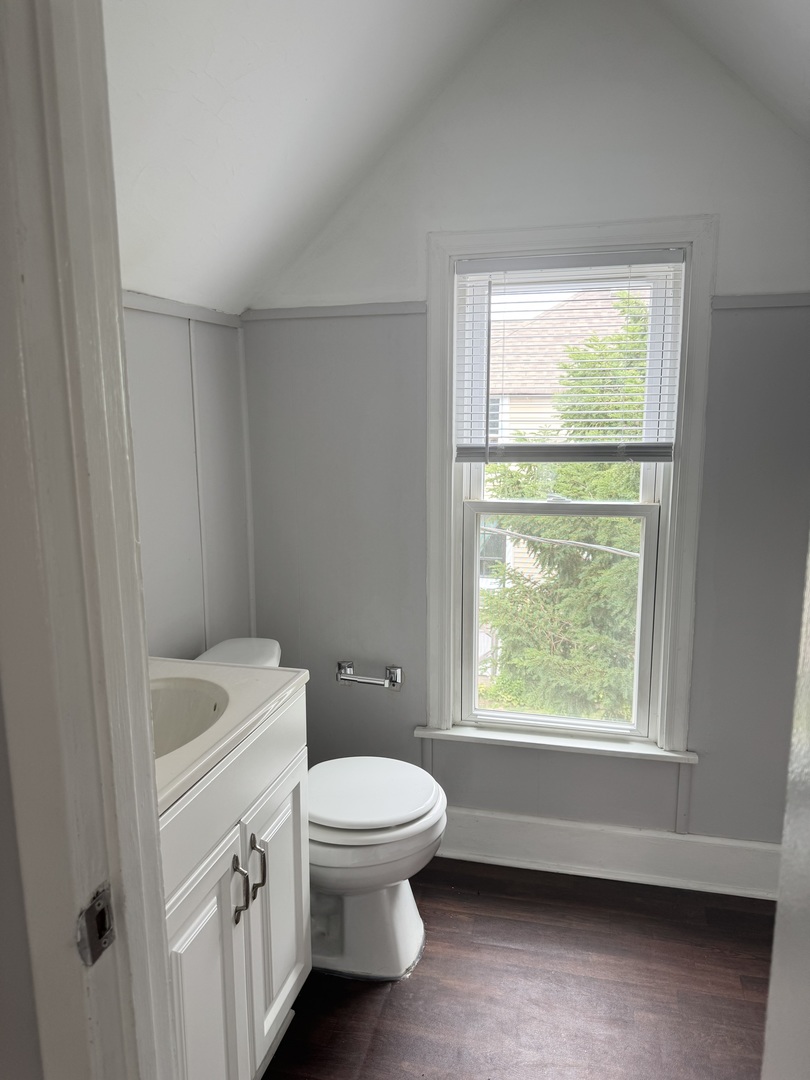 118 Wilcox Avenue Elgin, IL 60123 - Photo 24 of 29 a bathroom with a toilet a sink and a window