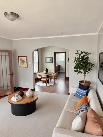 a kitchen with stainless steel appliances kitchen island granite countertop a stove a sink dishwasher and white cabinets with wooden floor