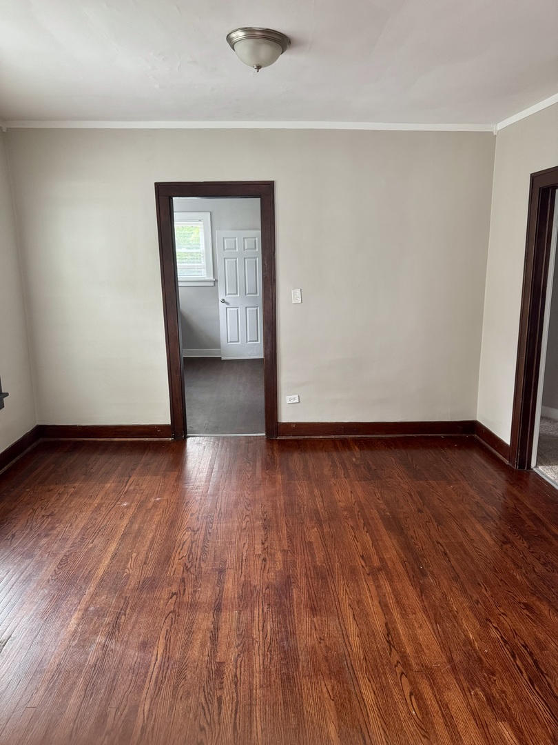 118 Wilcox Avenue Elgin, IL 60123 - Photo 8 of 29 wooden floor in an empty room with a window