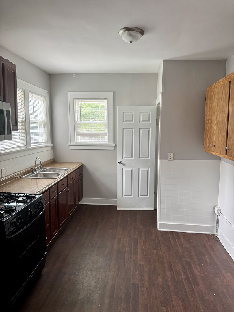 118 Wilcox Avenue Elgin, IL 60123 - Photo 9 of 29 a view of an empty room with window and wooden floor