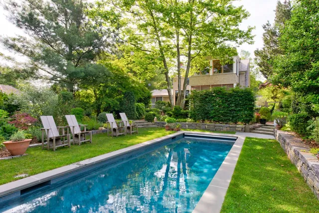 a view of a house with swimming pool and sitting area
