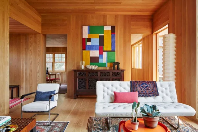a living room filled with furniture and a potted plant
