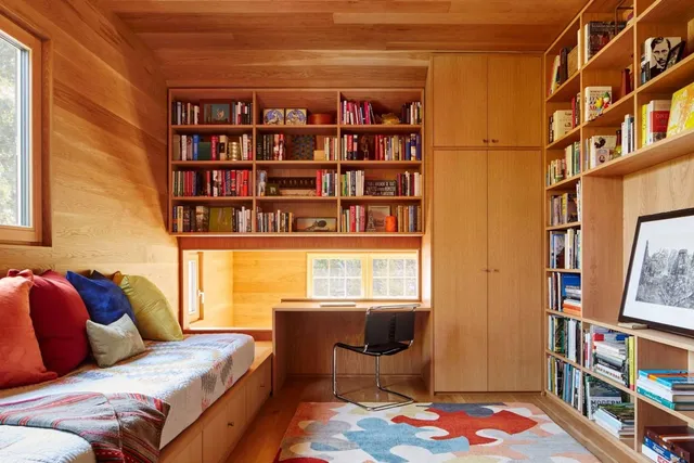 a bedroom with a bed furniture and a book shelf