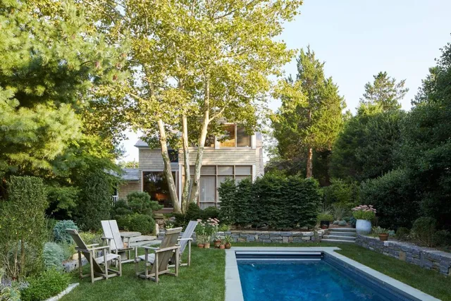 a view of a chairs and table in a backyard