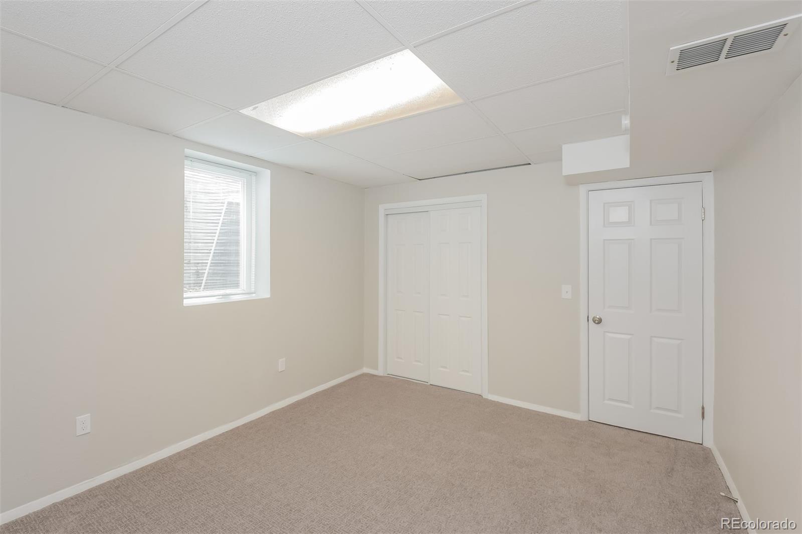 5522 Carson Street Denver, CO 80239 - Photo 11 of 17 an empty room with windows