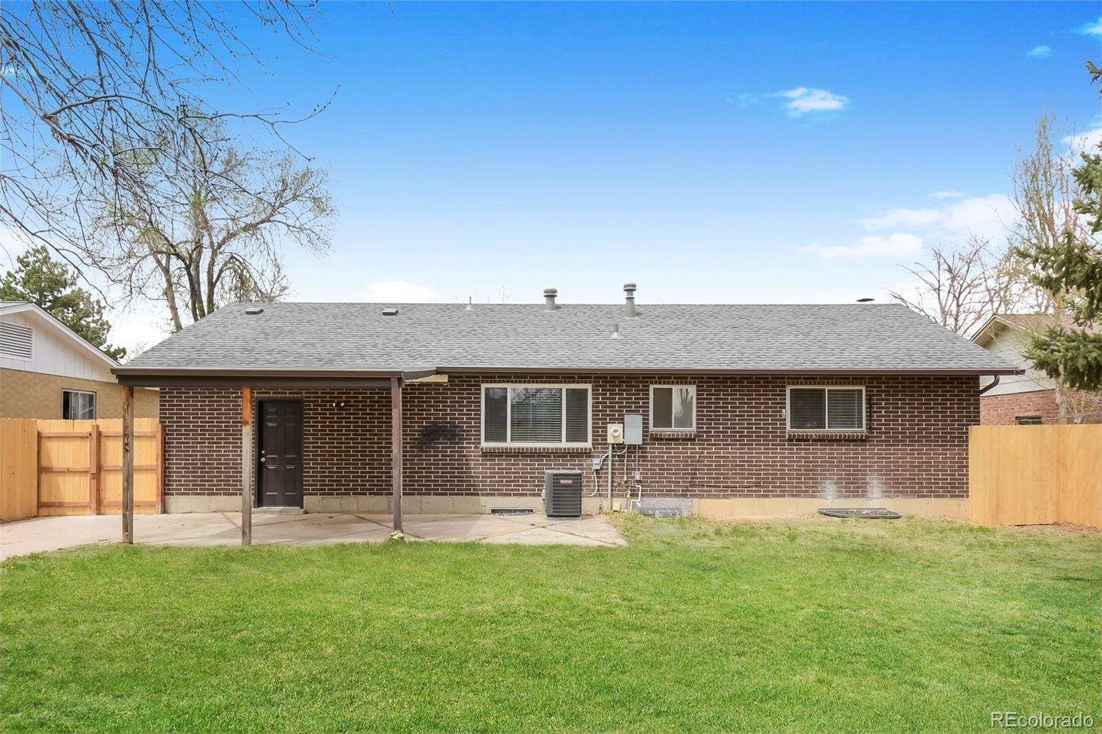 5522 Carson Street Denver, CO 80239 - Photo 14 of 17 a front view of house with yard and green space