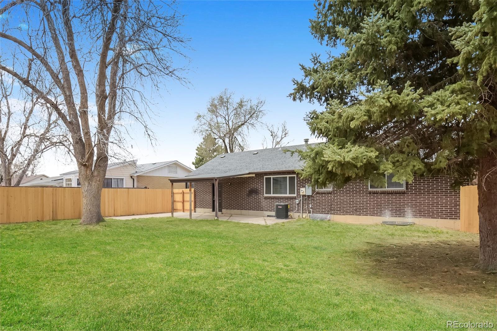 5522 Carson Street Denver, CO 80239 - Photo 15 of 17 a front view of house with yard and green space