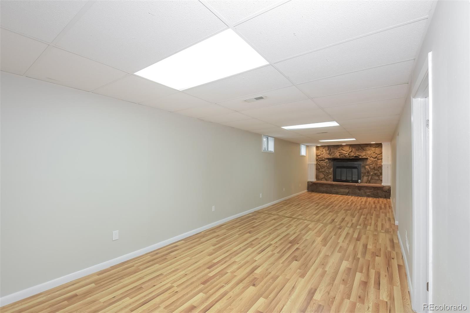 5522 Carson Street Denver, CO 80239 - Photo 10 of 17 a view of empty room with wooden floor
