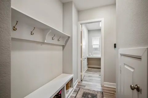 a room with a wooden floor and white doors