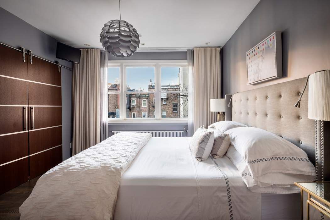 69 Washington Place, Unit 3/4/5 Manhattan, NY 10011 - Photo 10 of 26 a bedroom with a large bed and a window