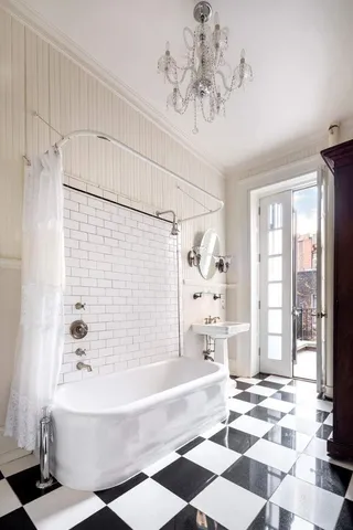 a bedroom with a large bed and a chandelier