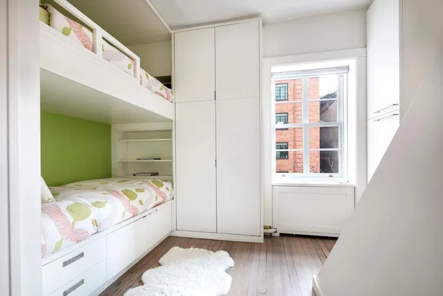 a bedroom with a bed and a fireplace