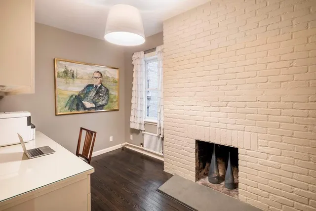 a bedroom with a bed and a chair in it