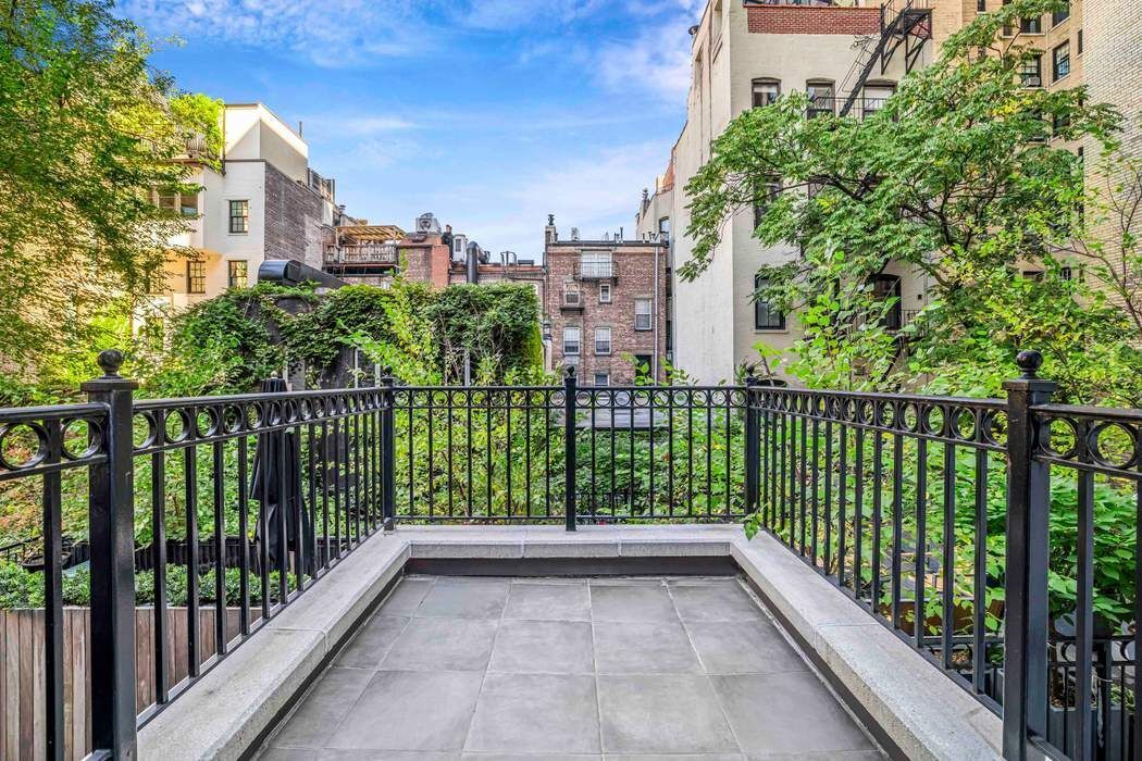69 Washington Place, Unit 3/4/5 Manhattan, NY 10011 - Photo 18 of 26 a view of a balcony with a floor to ceiling window and wooden fence