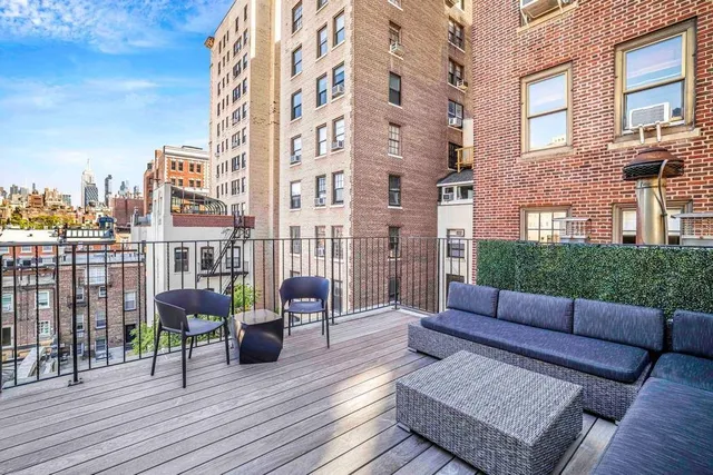 a view of a balcony with a floor to ceiling window and wooden fence