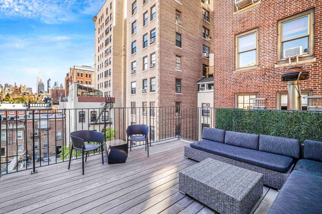 69 Washington Place, Unit 3/4/5 Manhattan, NY 10011 - Photo 19 of 26 a view of a rooftop deck with couch and chairs
