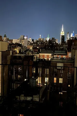 a view of a street with trees and houses in the background