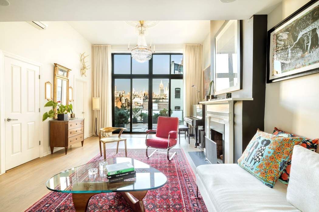 69 Washington Place, Unit 3/4/5 Manhattan, NY 10011 - Photo 2 of 26 a living room with furniture large window and wooden floor