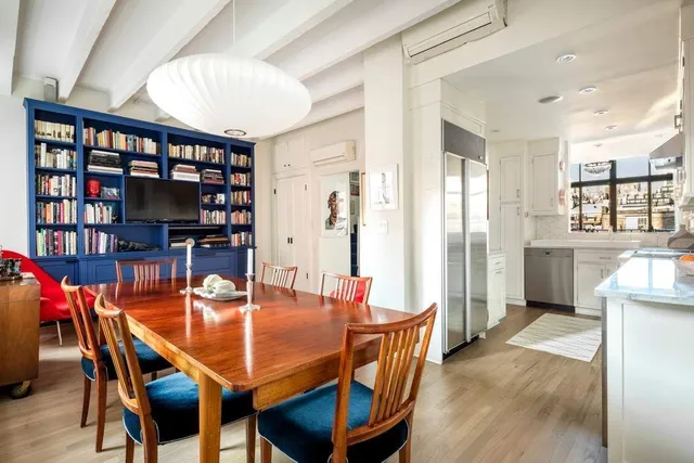 a view of a dining room with furniture window and wooden floor