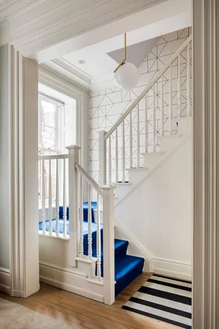 a kitchen with stainless steel appliances granite countertop a stove top oven a sink a dining table and chairs with wooden floor