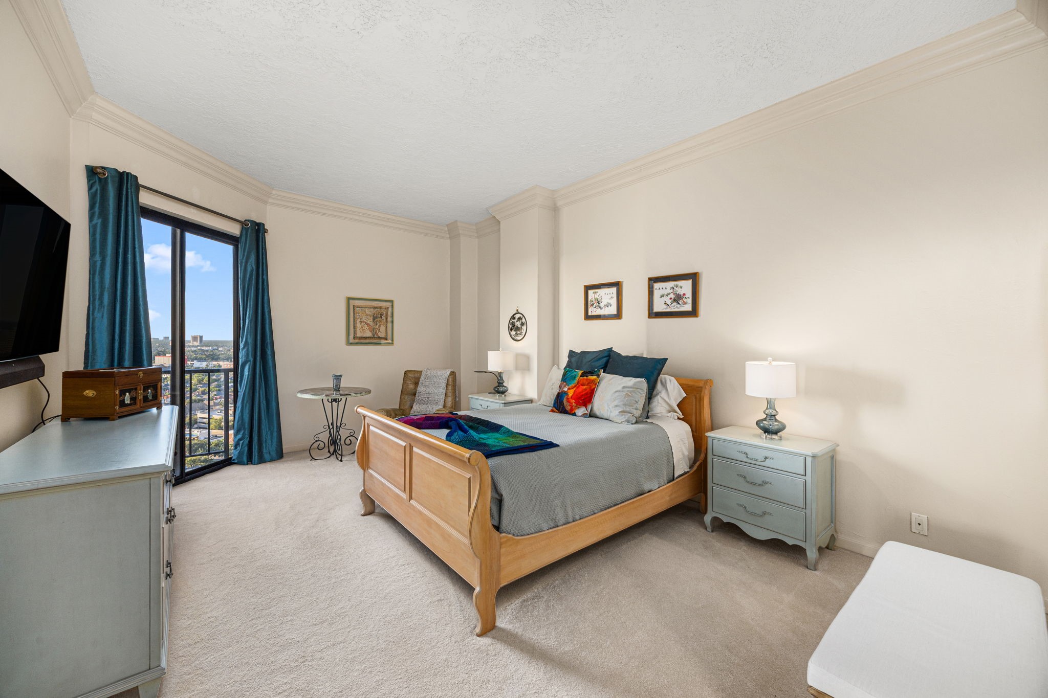 3350 McCue Road, Unit 2302 Houston, TX 77056 - Photo 14 of 35 Bedroom 1 - the primary bedroom is large enough to accommodate oversized furniture as well as a sitting area. Walk-in closet to the left (not visible). Notice the elegant crown moulding!