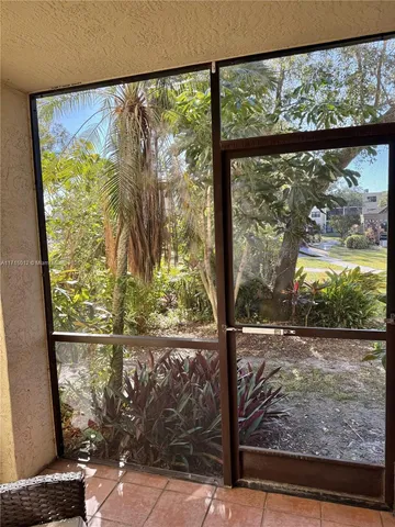 a view of a room with a large window and sitting area