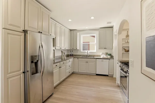 a kitchen with cabinets and refrigerator
