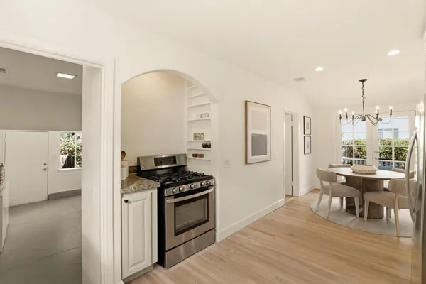 a kitchen with stainless steel appliances granite countertop a stove and a refrigerator
